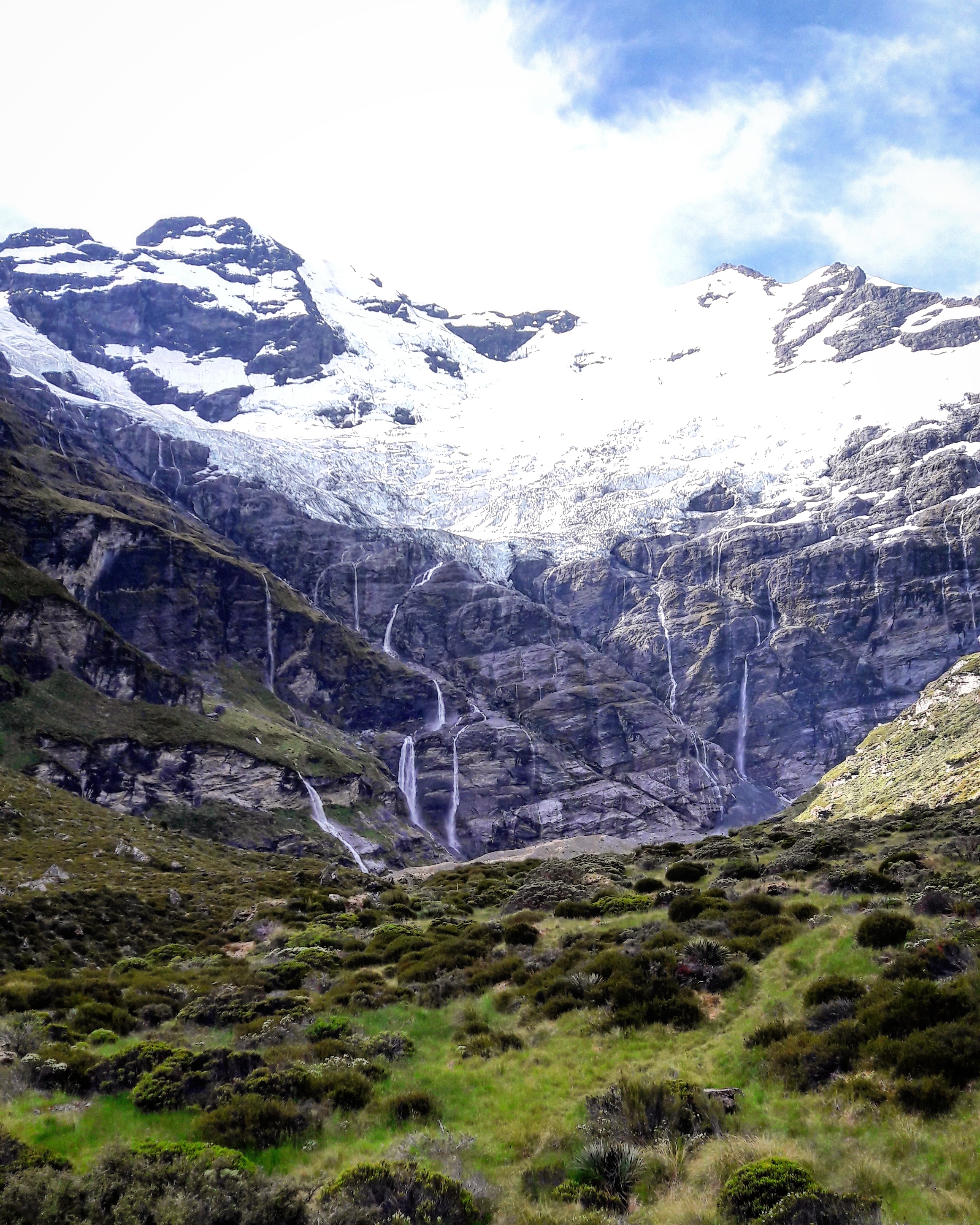Hanging glaciers and waterfalls cascading off cliffs at the head of Earnslaw Burn