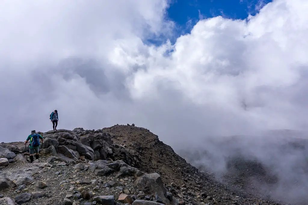 Trampers climbing down Mt Ruapehu in building low cloud