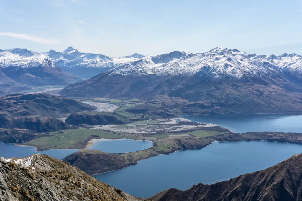 View from Roys Peak over Glendhu Bay with Mt Aspiring and snowy mountains in the background