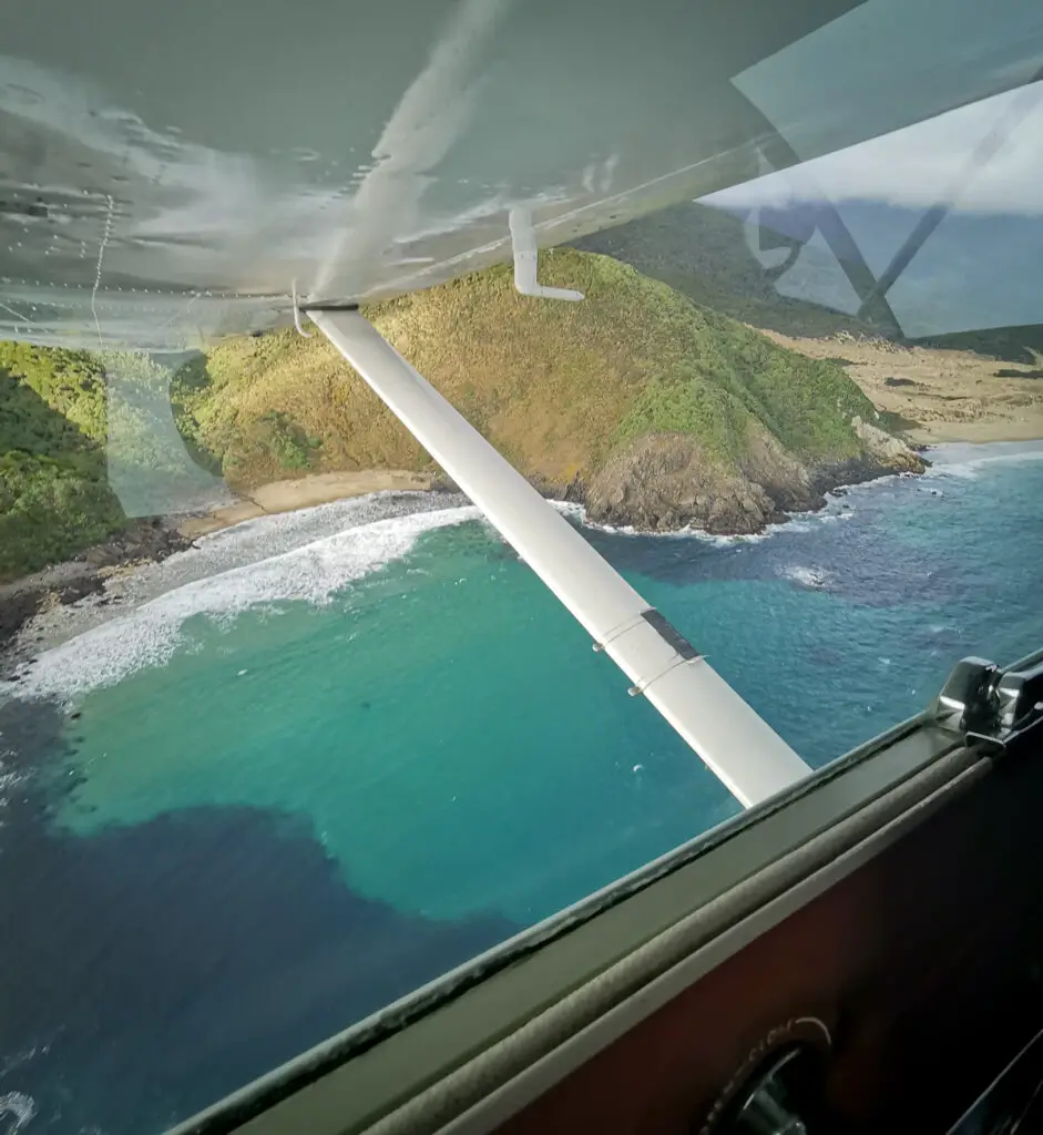 View of turquoise waters and beautiful beaches of Stewart Island from a plane
