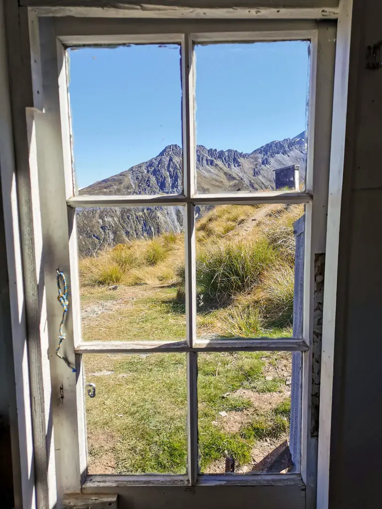 View out the glass door of Heather Jock Hut near Glenorchy in Whakaari Conservation Area