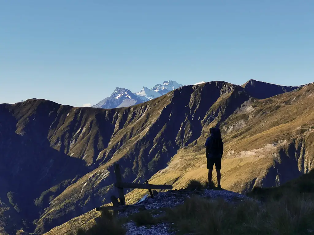 Hiker standing silhouetted against the mountains near Glenorchy