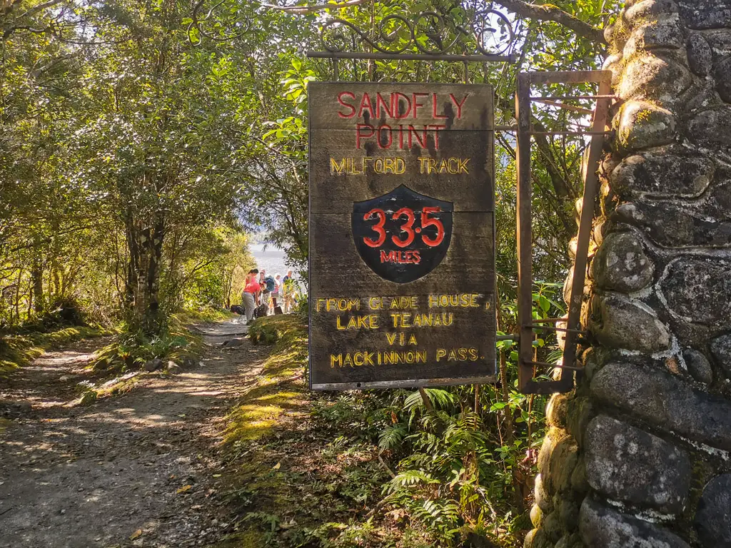 The end of the Milford Track with the signpost at Sandfly Point