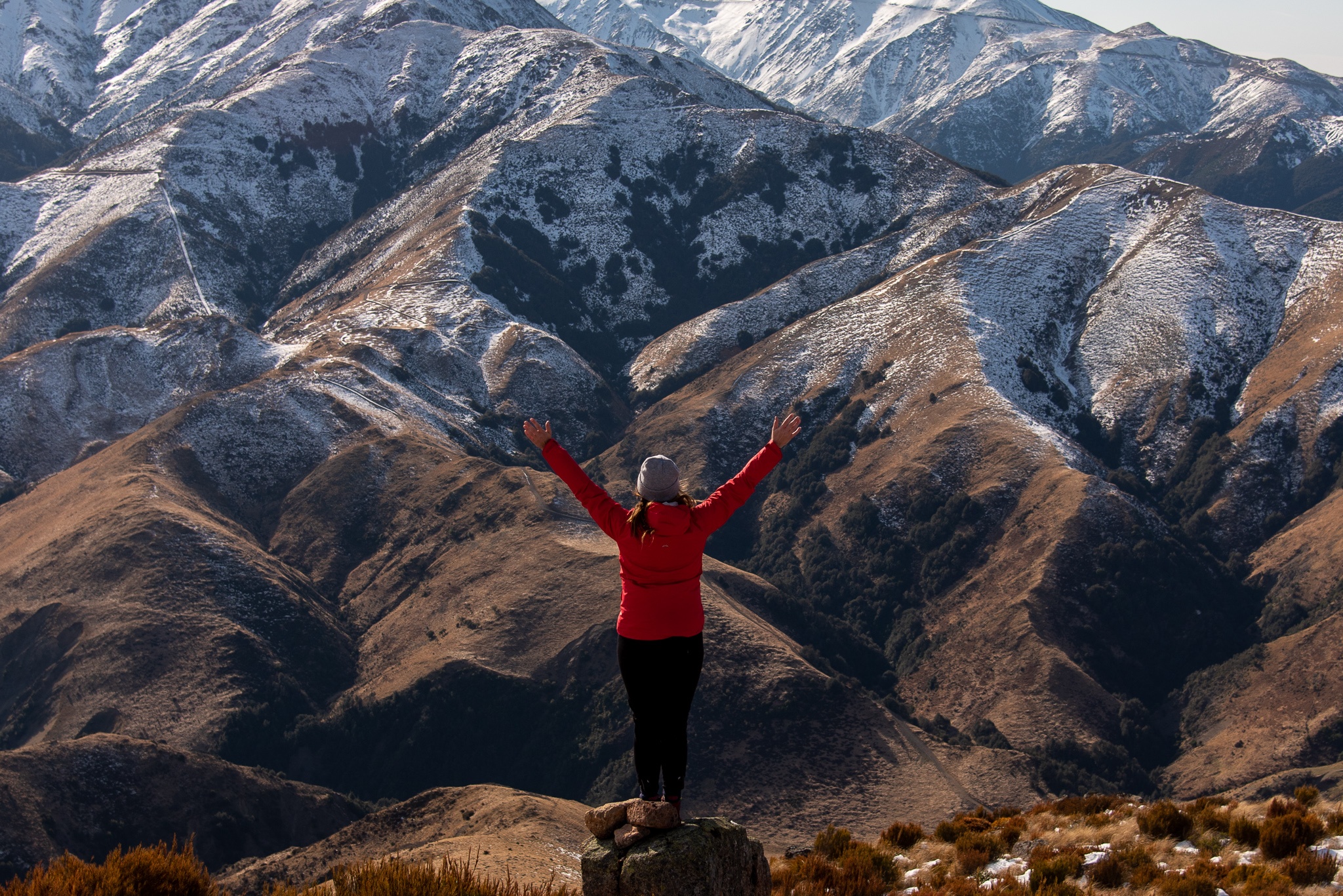 Woman standing in front of snowy mountains
