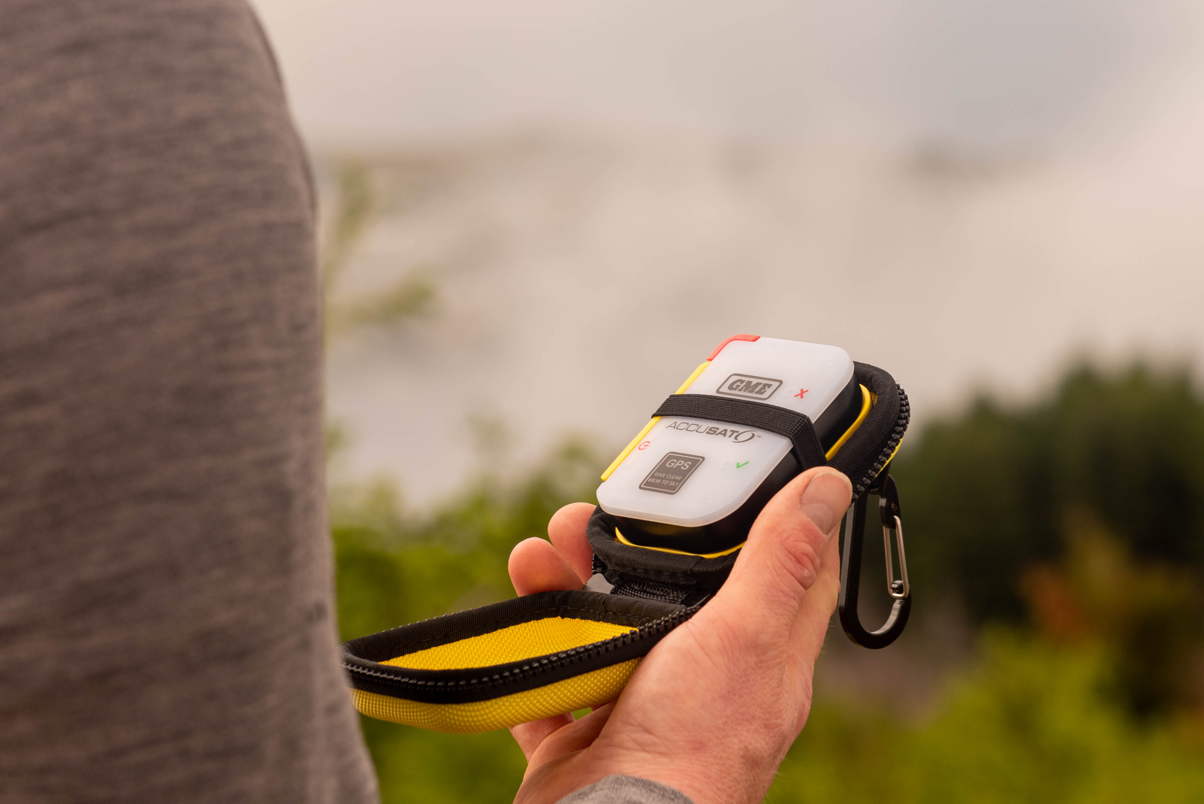 Someone holding a personal locator beacon
