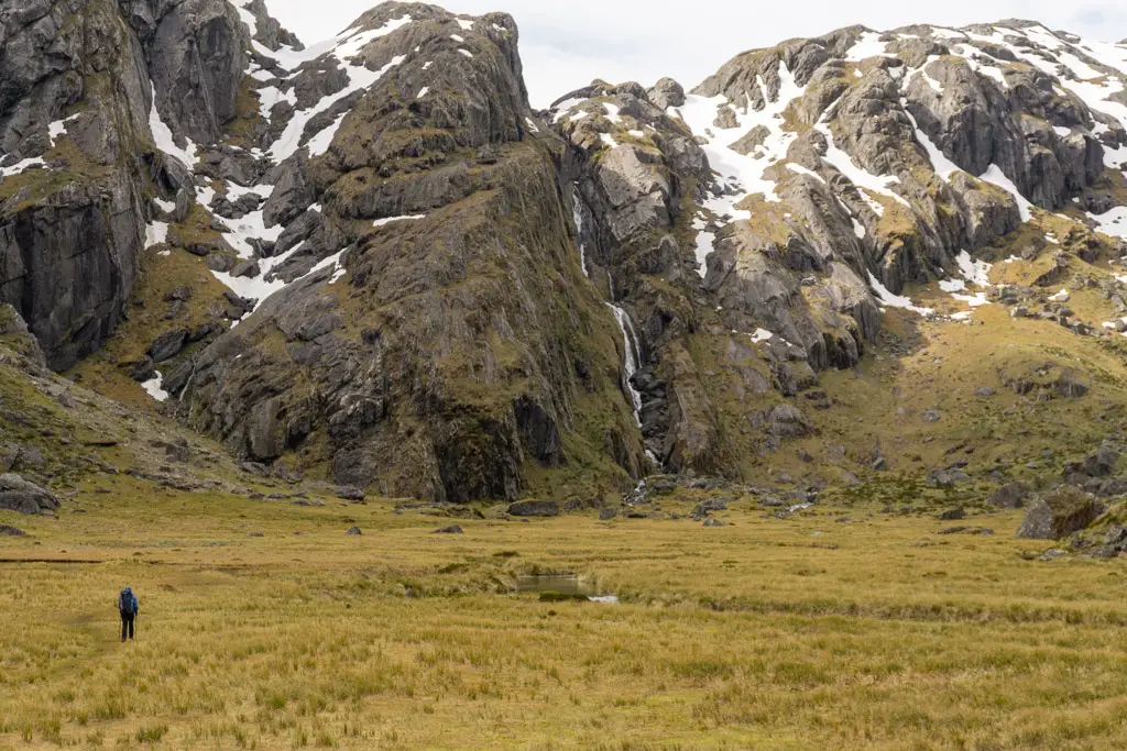 Tramper walking through Valley of the Trolls in Mt Aspiring National Park
