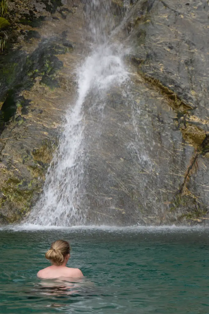 Woman swimming in a waterfall near Siberia Hut