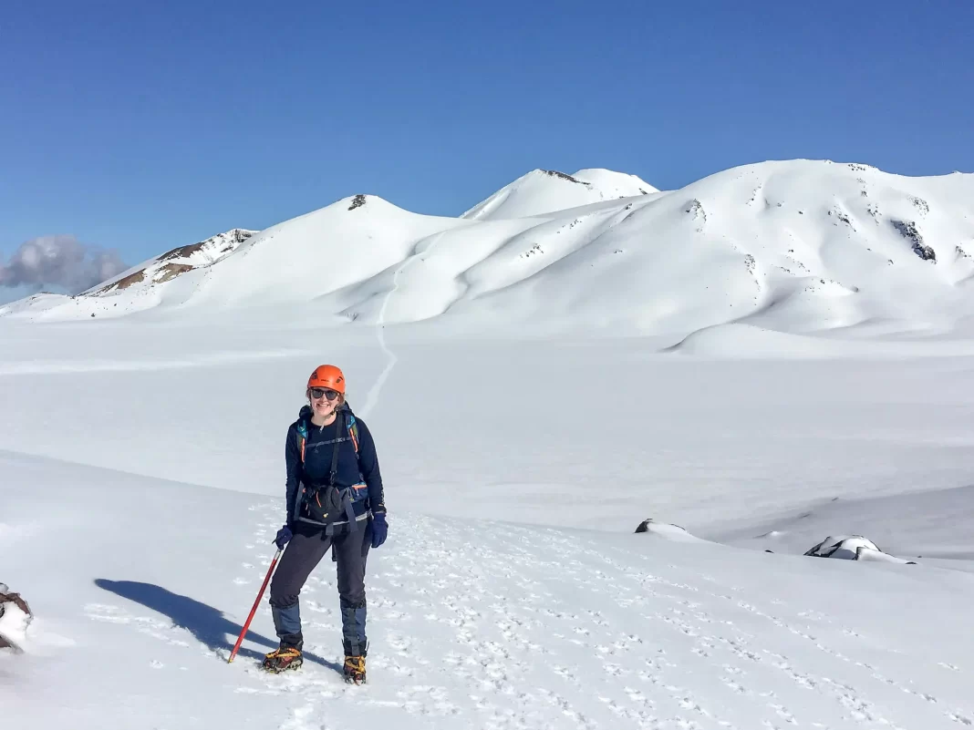 Hiker on the Tongariro Crossing in winter with snow covering the ground