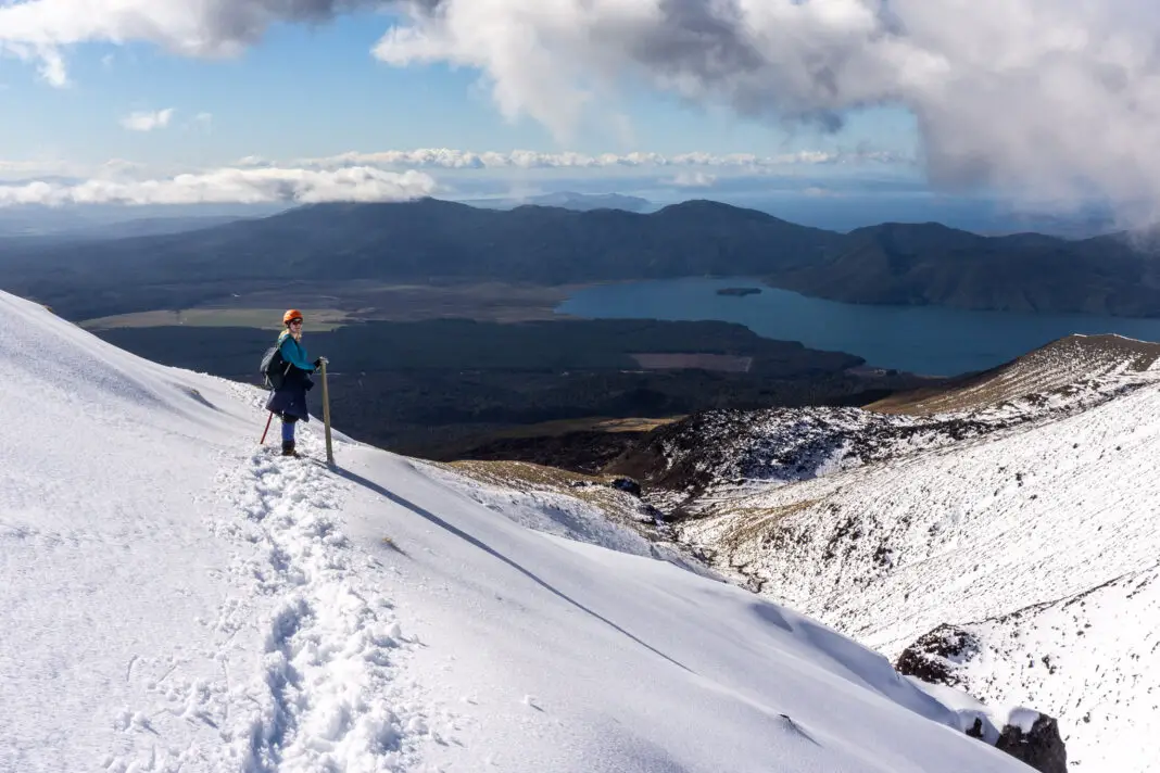 Person standing on a snowy slope on the Tongariro Crossing in winter