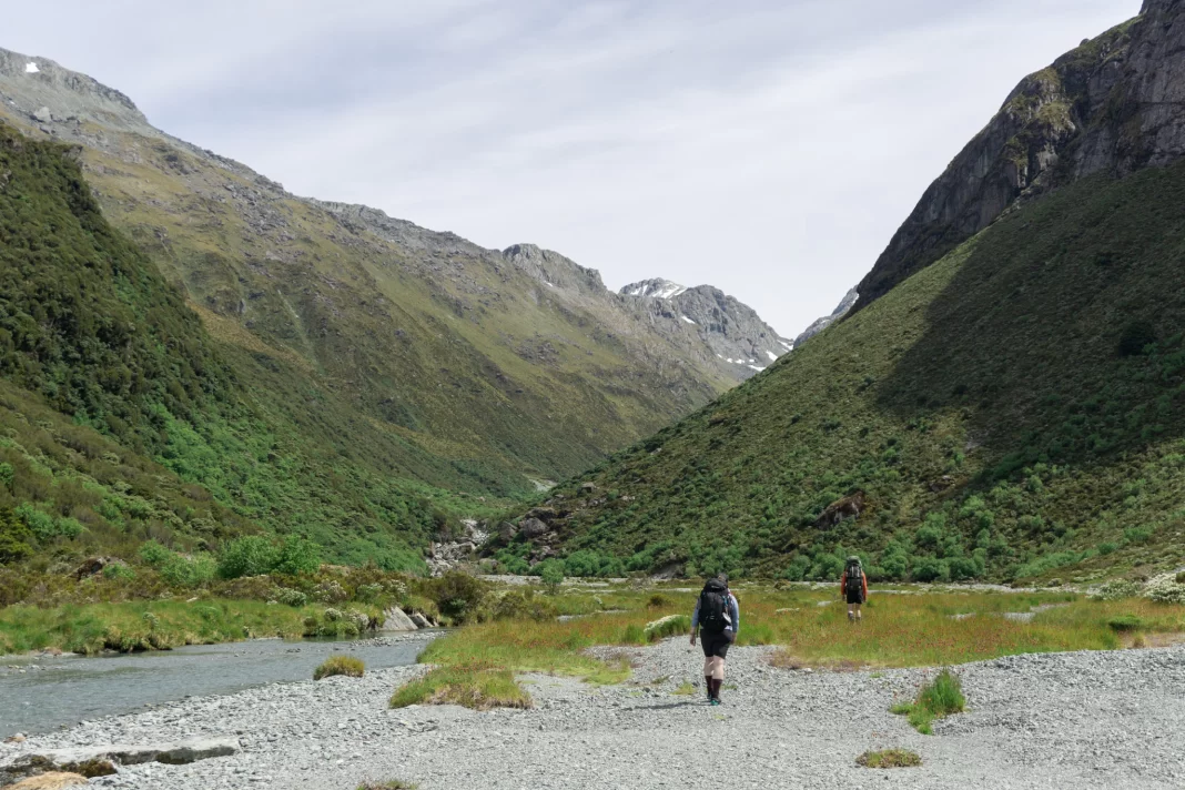 Trampers walking up the North Branch of the Routeburn towards North Col