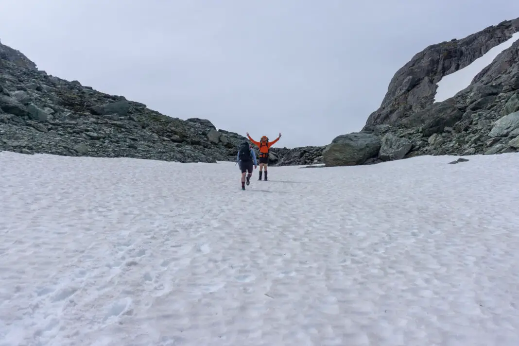 Two trampers climbing up a snow slope towards North Col