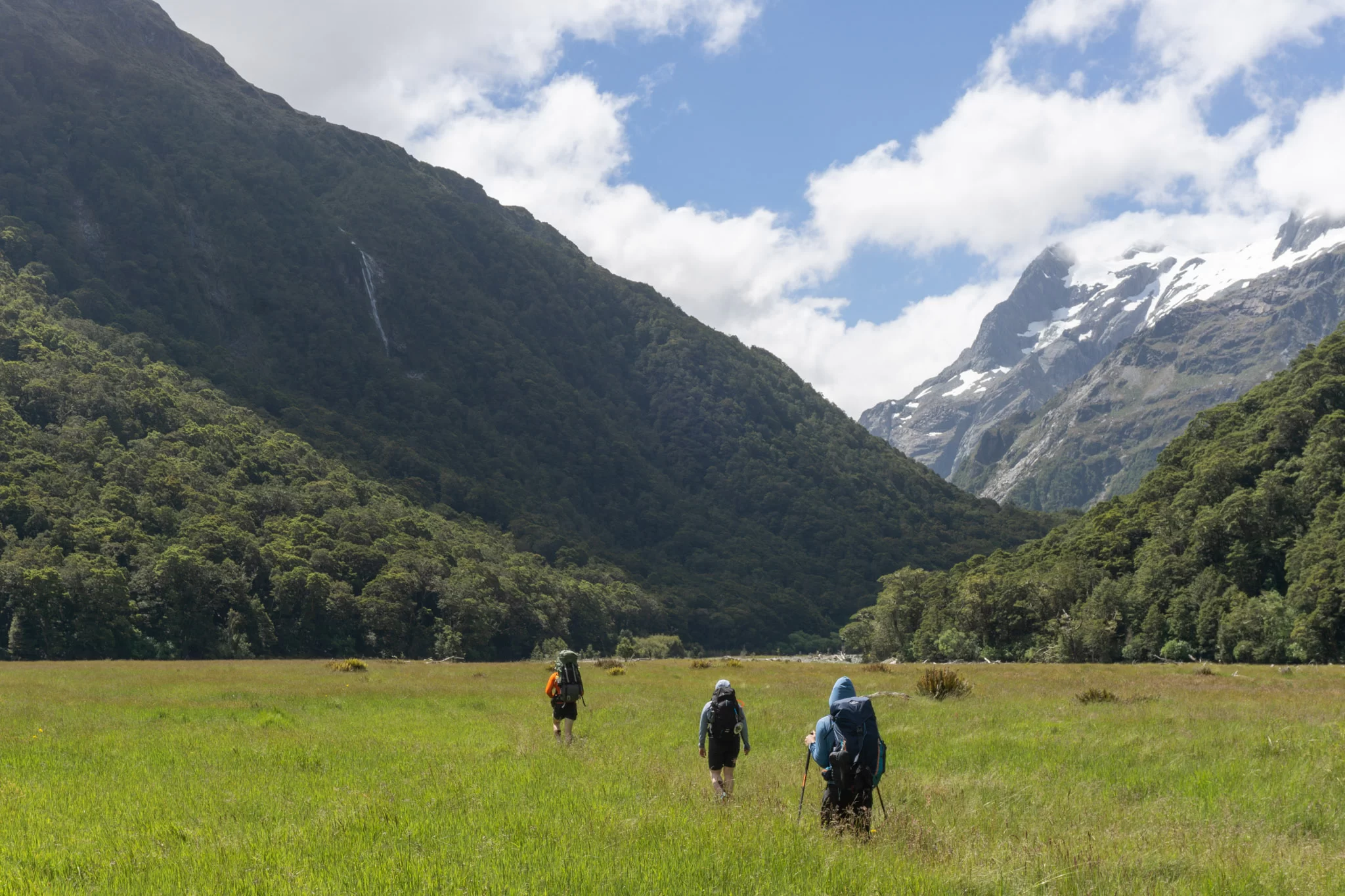 Three trampers crossing Routeburn Flats on the way to North Col