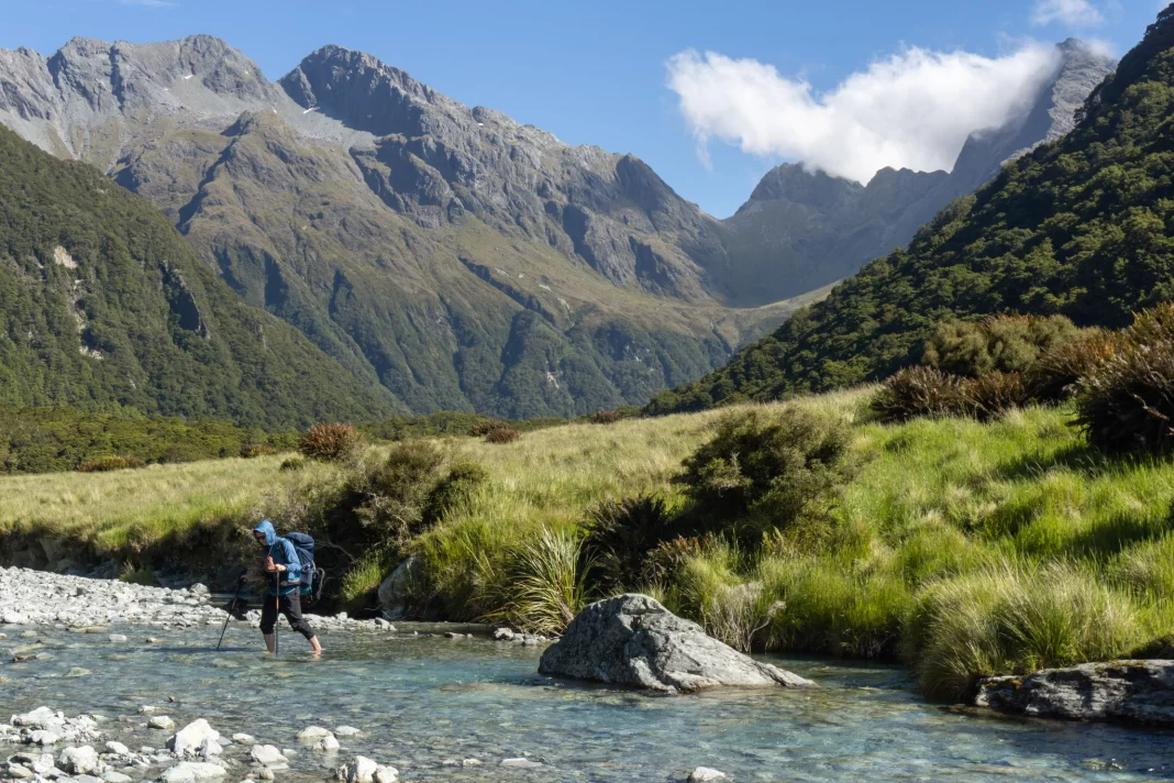 Tramper crossing the North Branch of the Routeburn