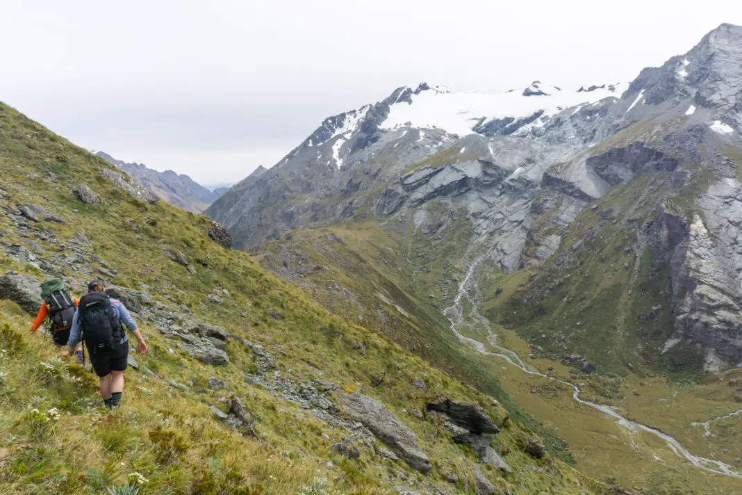 Trampers walking along a steep traverse towards Park Pass