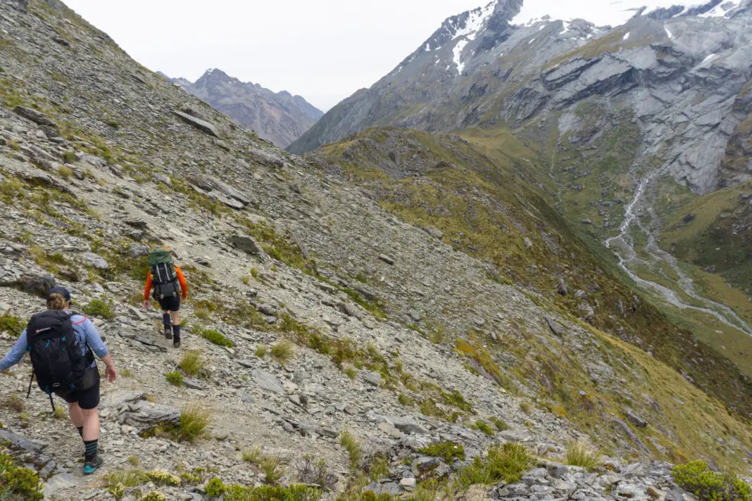 Trampers walking along a steep traverse towards Park Pass