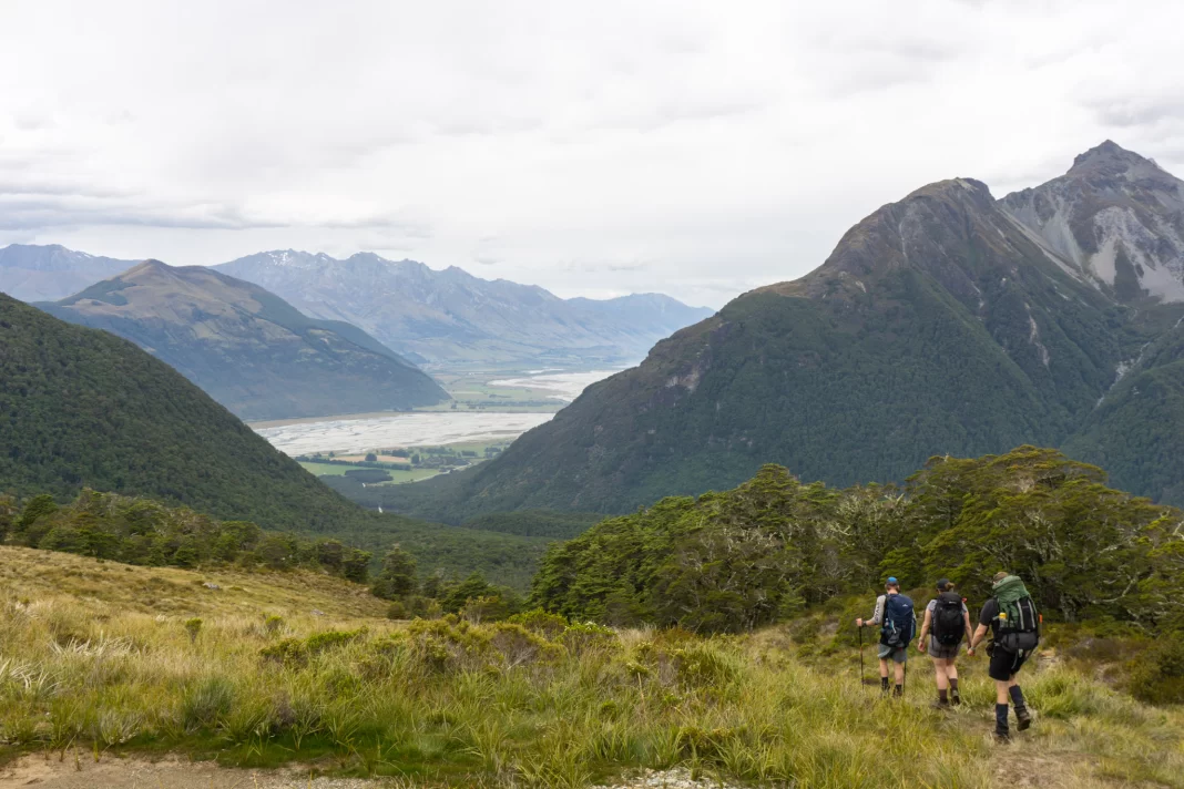 Trampers walking along Sugarloaf Pass with view towards Glenorchy
