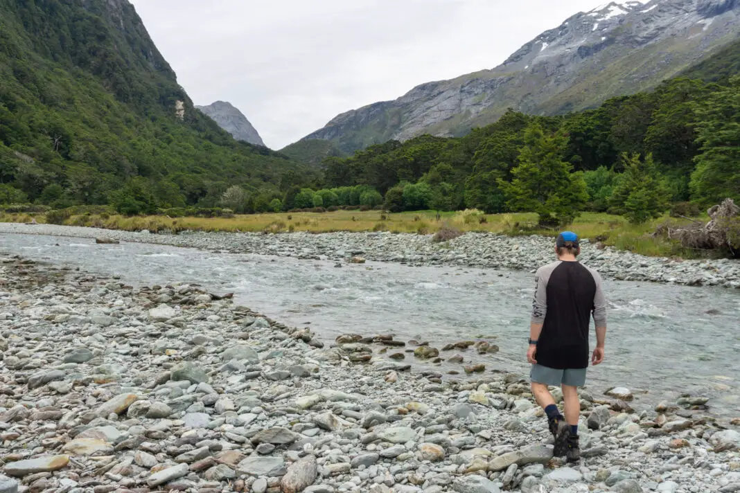 Tramper standing next to the Rockburn looking towards Theatre Flat and Park Pass