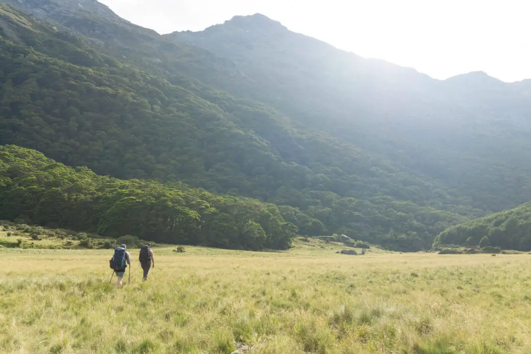 Trampers walking at sunrise on Theatre Flat