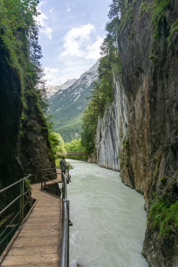 Man walking on cantilevered walkway near Leutasch-Klamm Wasserfallsteig walk near Mittenwald