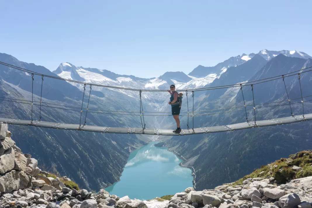 Woman standing on the bridge at Olpererhutte in Austria