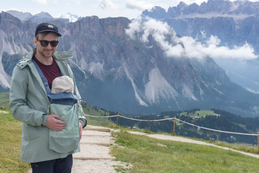 Man holding baby in Seceda, Dolomites