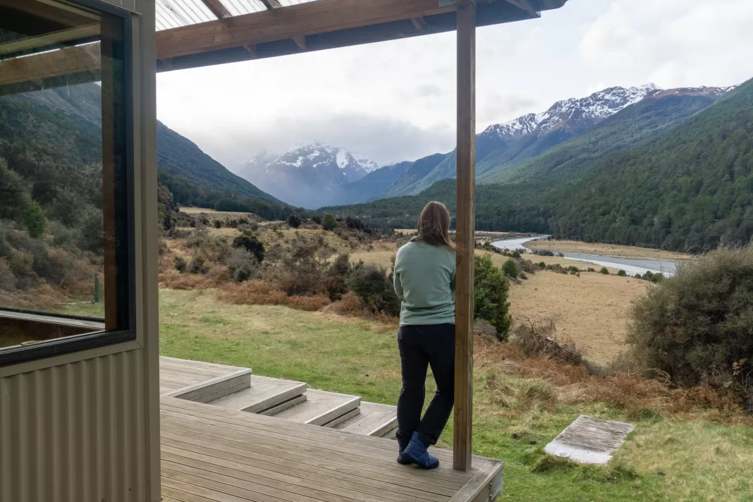 Tramper standing at Mid Caples Hut during a winter tramping trip