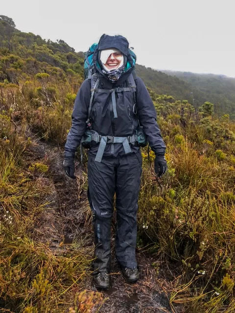 Woman with a bandaged eye and wearing hiking gear while attempting to self-rescue after an eye injury