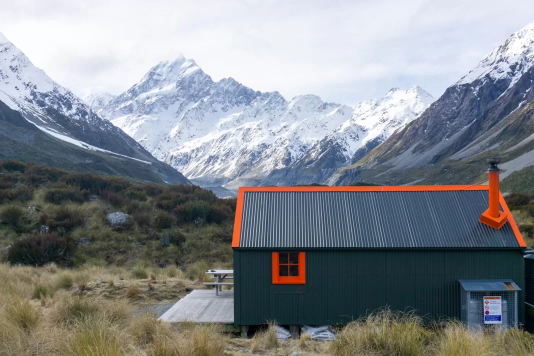 Photo of Hooker Hut with Aoraki Mt Cook in the background