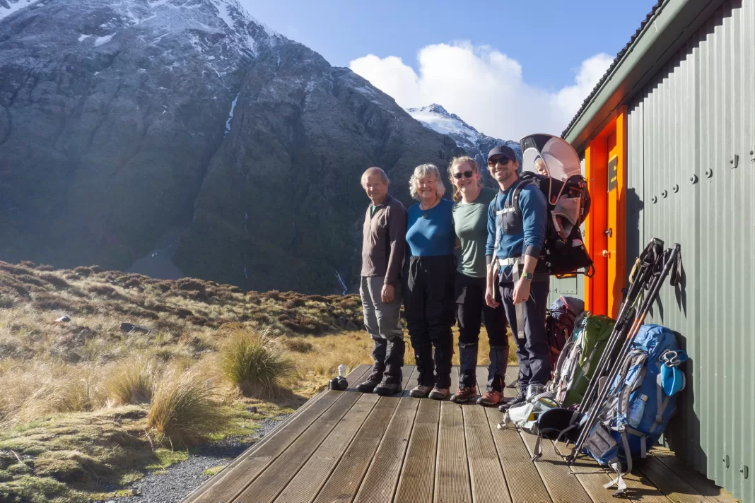 Group of trampers getting ready to depart Hooker Hut