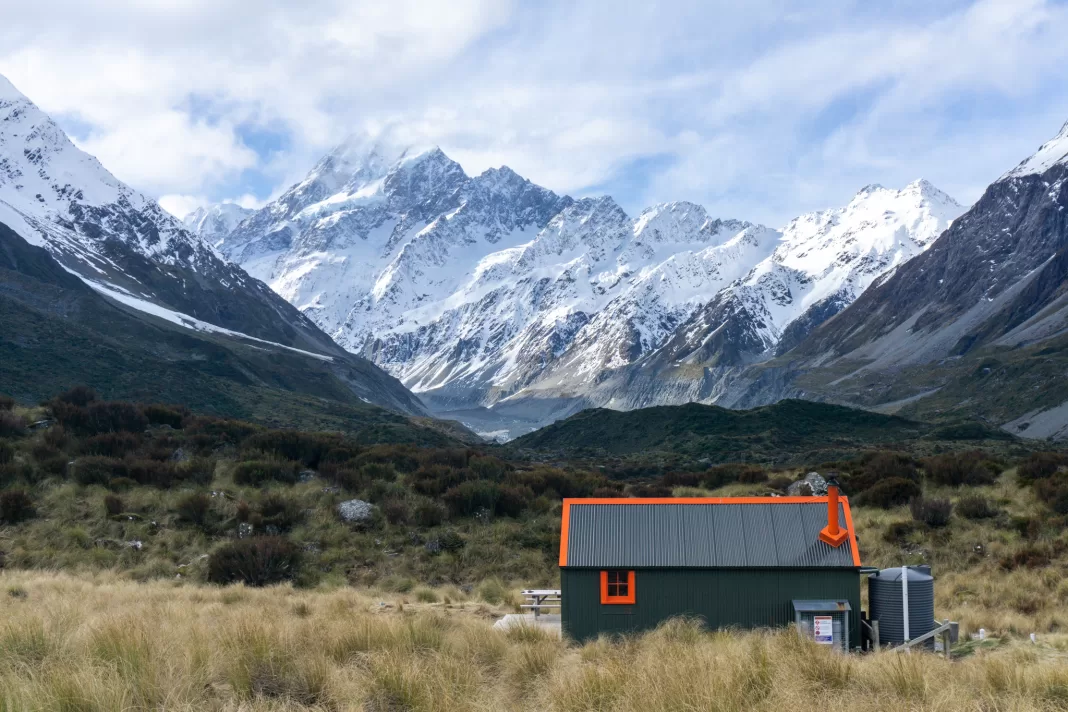 Photo of Hooker Hut with Aoraki Mt Cook and Hooker Lake in the background