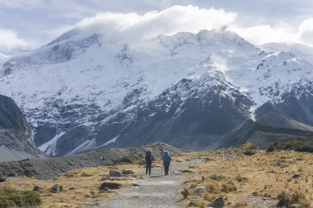 Two hikers on the Hooker Valley Track in Aoraki Mt Cook National Park