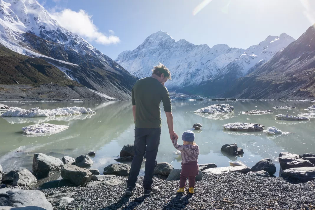 Man and toddler at Hooker Lake looking at icebergs