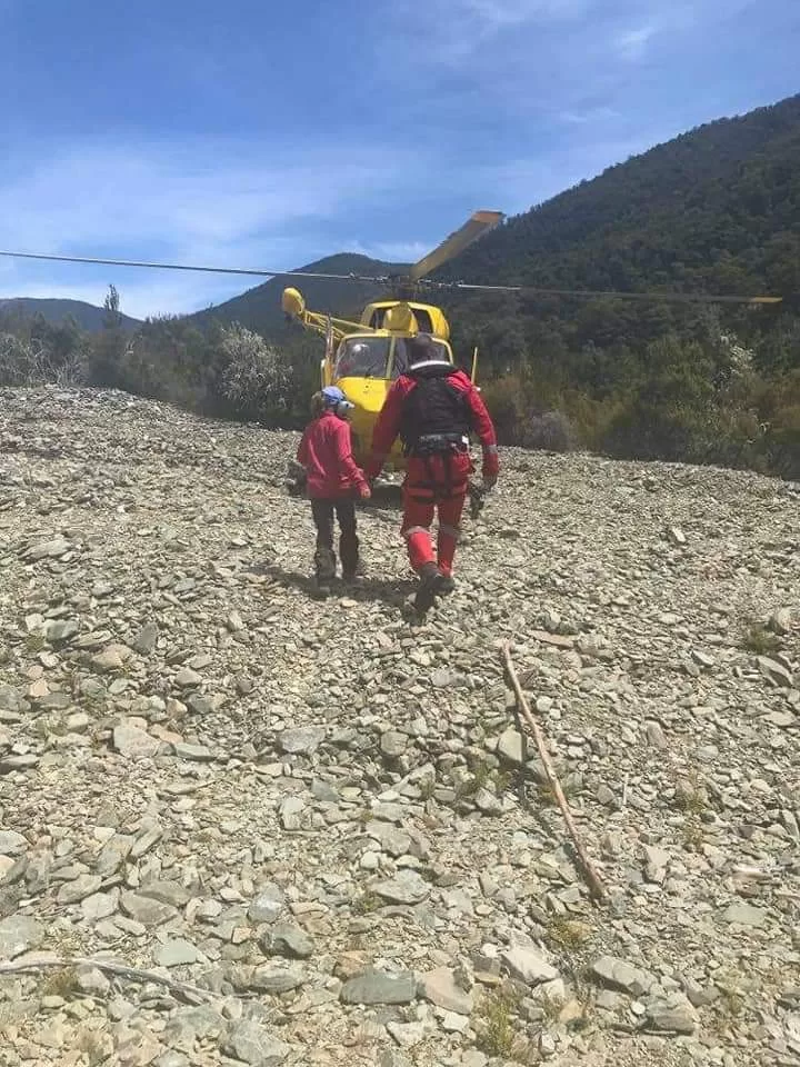 Two people walking towards a rescue helicopter