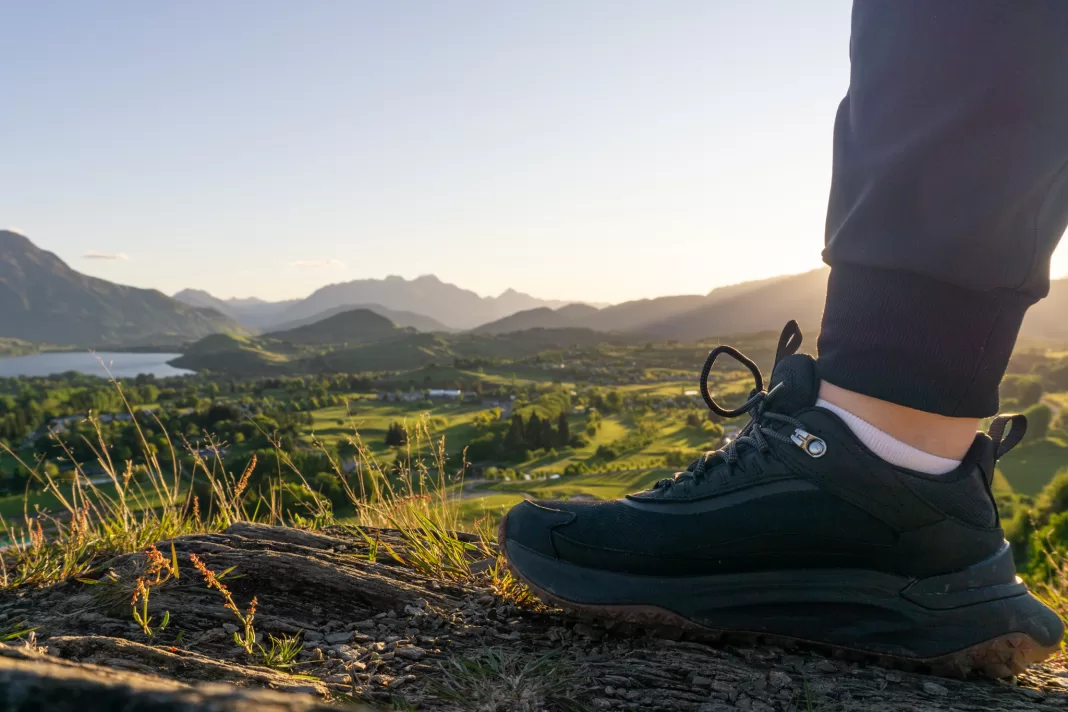 Photo of Timberland Motion Access hiking shoe posed on a trail with a a lake in the background