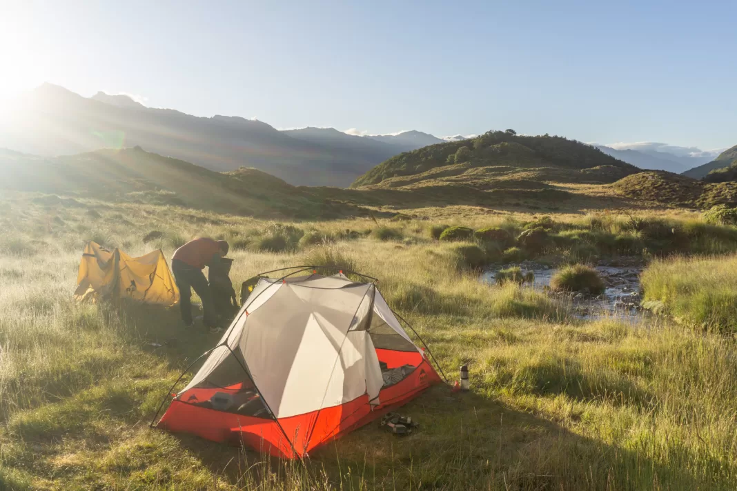 Packing up a tent at sunrise