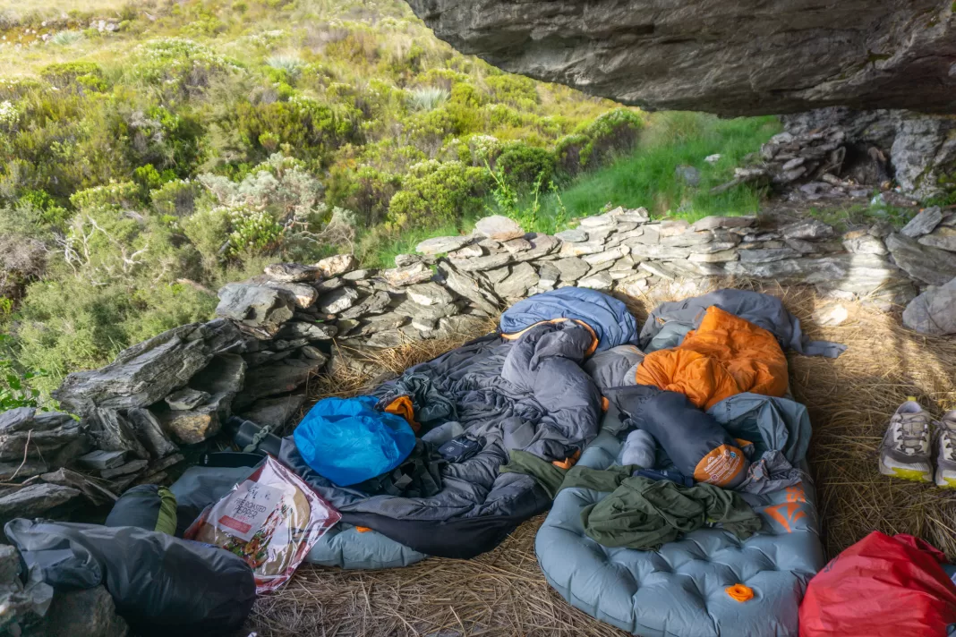 Two sleeping mats set up in the rock bivy in Kea Basin