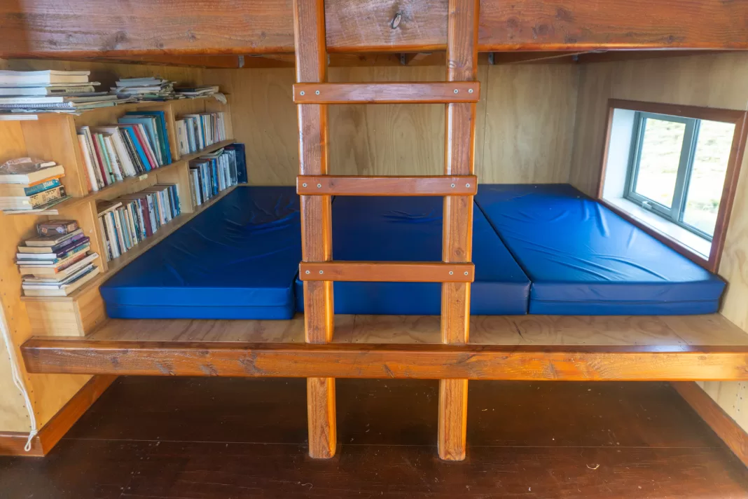Bookcase and bunks at Mataketake Hut