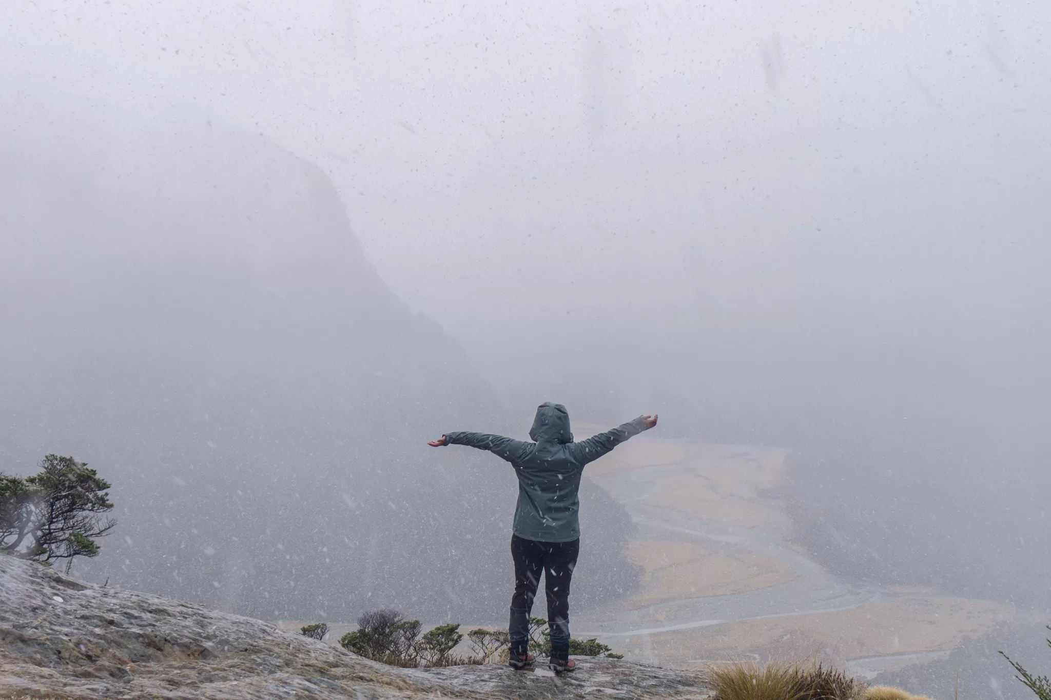 Woman standing in the snow in the mountains