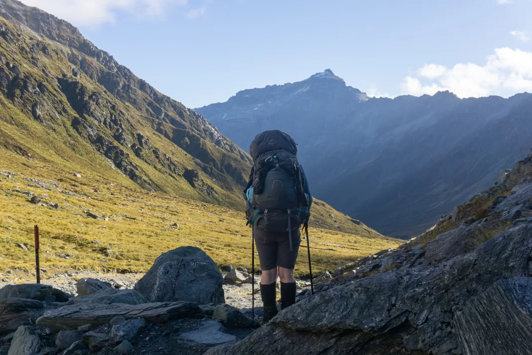 Tramper walking at sunset along the Rees Valley