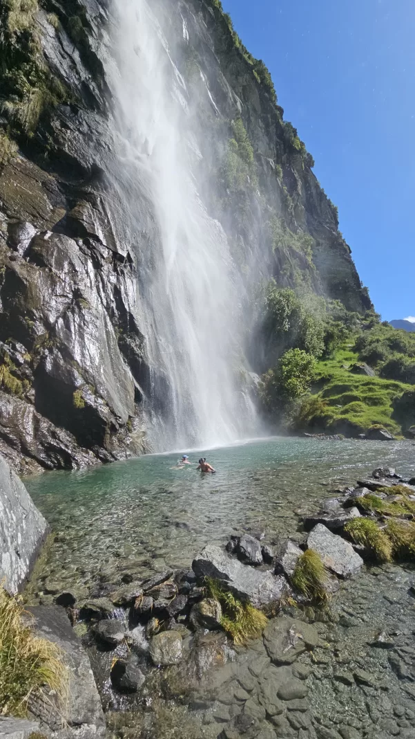 People swimming in the pool below Wishbone Falls