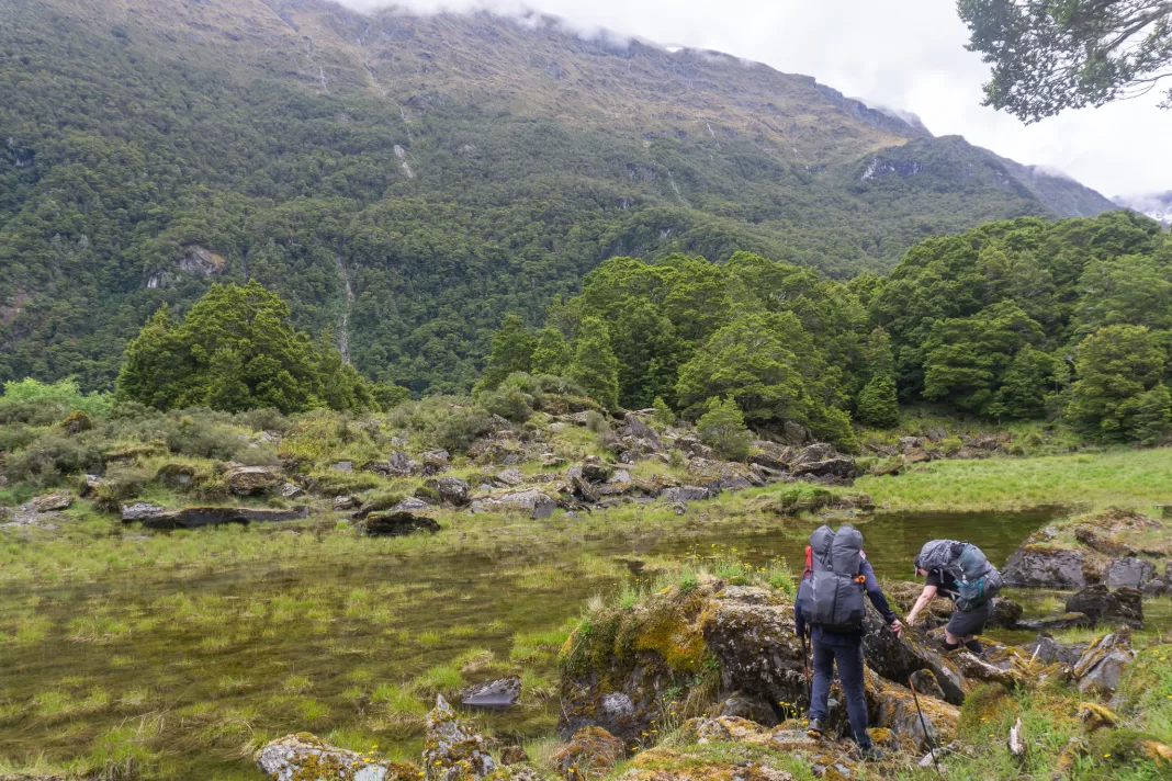 Trampers climbing in the Wilkin Valley towards Top Forks Hut