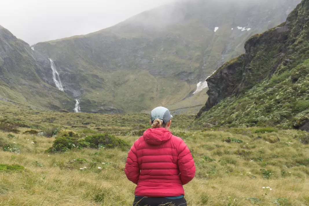 Tramper standing in front of a misty Waterfall Face on Rabbit Pass